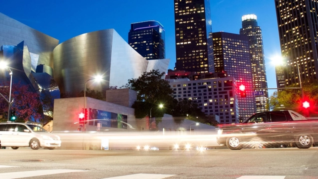 Cars at the intersection of Grand Street and First Street in downtown Los Angeles at night, in front of Disney Concert Hall.